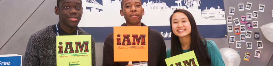 Students holding iAM signs